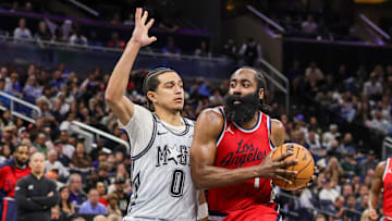 Mar 31, 2025; Orlando, Florida, USA; LA Clippers guard James Harden (1) drives against Orlando Magic guard Anthony Black (0) during the second half at Kia Center. Mandatory Credit: Mike Watters-Imagn Images