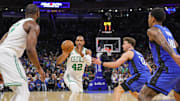 Apr 25, 2025; Orlando, Florida, USA; Boston Celtics center Al Horford (42) passes the ball against Orlando Magic forward Franz Wagner (22) during the second half of game three of first round for the 2024 NBA Playoffs at Kia Center. Mandatory Credit: Mike Watters-Imagn Images