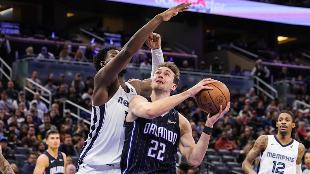 Feb 21, 2025; Orlando, Florida, USA; Orlando Magic forward Franz Wagner (22) is fouled by Memphis Grizzlies forward Jaren Jackson Jr. (13) during the second quarter at Kia Center. Mandatory Credit: Mike Watters-Imagn Images