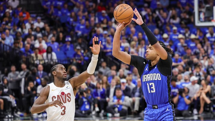 Apr 25, 2024; Orlando, Florida, USA; Orlando Magic guard Jett Howard (13) shoots a three point basket over Cleveland Cavaliers guard Caris LeVert (3) during the second half of game three of the first round for the 2024 NBA playoffs at Kia Center. Mandatory Credit: Mike Watters-Imagn Images