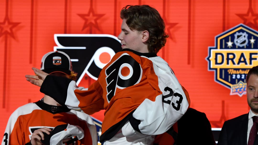 Jun 28, 2023; Nashville, Tennessee, USA; Philadelphia Flyers draft pick Oliver Bonk puts on his sweater after being selected with the twenty second pick in round one of the 2023 NHL Draft at Bridgestone Arena. Mandatory Credit: Christopher Hanewinckel-USA TODAY Sports