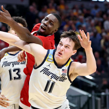 Mar 29, 2024; Dallas, TX, USA; North Carolina State Wolfpack forward Mohamed Diarra (23) and Marquette Golden Eagles guard Tyler Kolek (11) fight for a loose ball during the second half in the semifinals of the South Regional of the 2024 NCAA Tournament at American Airlines Center. Mandatory Credit: Kevin Jairaj-USA TODAY Sports 