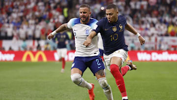 Dec 10, 2022; Al Khor, Qatar; England defender Kyle Walker (2) and France forward Kylian Mbapp   (10) chase the ball during the second half of a quarterfinal game in the 2022 FIFA World Cup at Al-Bayt Stadium. Mandatory Credit: Yukihito Taguchi-Imagn Images
