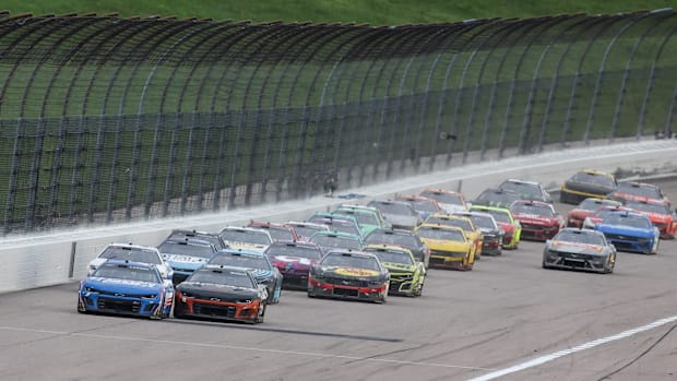 NASCAR Cup Series drivers race down the back stretch during the Advent Health 400 at the Kansas Speedway. 