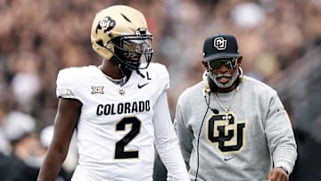 Quarterback Shedeur Sanders #2 talk with Head Coach Deion Sanders of the Colorado Buffaloes prior to the game against the UCF Knights at FBC Mortgage Stadium on September 28, 2024 in Orlando, Florida. The Buffaloes defeated the Knights 48-21.