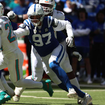 Sep 7, 2025; Indianapolis, Indiana, USA; Miami Dolphins running back De'Von Achane (28) runs against Indianapolis Colts defensive end Laiatu Latu (97) during the first half at Lucas Oil Stadium. Mandatory Credit: Trevor Ruszkowski-Imagn Images