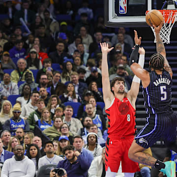 Jan 23, 2025; Orlando, Florida, USA; Orlando Magic forward Paolo Banchero (5) shoots against Portland Trail Blazers forward Deni Avdija (8) and center Robert Williams III (35) during the second half at Kia Center. Mandatory Credit: Mike Watters-Imagn Images