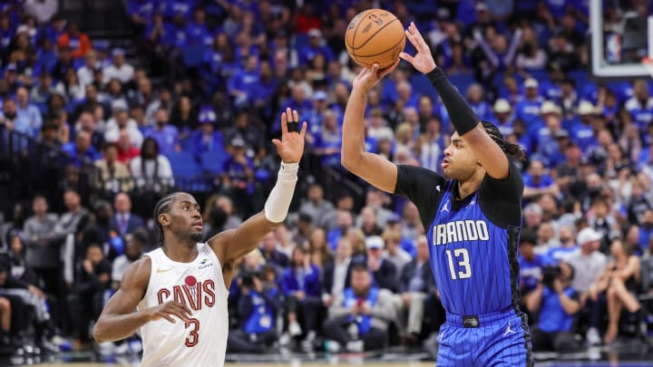 Orlando Magic guard Jett Howard (13) shoots a three-pointer over Cleveland Cavaliers guard Caris LeVert (3) during the second half of game three of the first round for the 2024 NBA playoffs at Kia Center. 
