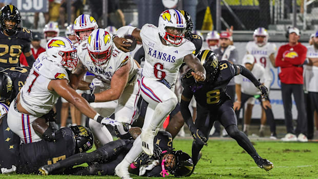 Kansas Jayhawks quarterback Jalon Daniels (6) carries the ball during the second quarter against the UCF Knights