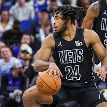 Dec 29, 2024; Orlando, Florida, USA; Brooklyn Nets guard Cam Thomas (24) moves the ball in front of Orlando Magic guard Gary Harris (14) during the second half at Kia Center. Mandatory Credit: Mike Watters-Imagn Images