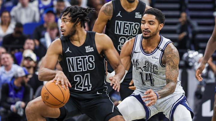 Dec 29, 2024; Orlando, Florida, USA; Brooklyn Nets guard Cam Thomas (24) moves the ball in front of Orlando Magic guard Gary Harris (14) during the second half at Kia Center. Mandatory Credit: Mike Watters-Imagn Images