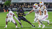 Oct 4, 2025; Orlando, Florida, USA; UCF Knights running back Myles Montgomery (22) runs the ball as Kansas Jayhawks cornerback Jalen Todd (26) moves in during the second quarter at FBC Mortgage Stadium. Mandatory Credit: Mike Watters-Imagn Images