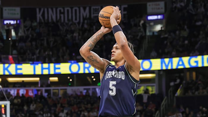 Apr 7, 2024; Orlando, Florida, USA; Orlando Magic forward Paolo Banchero (5) shoots a three point