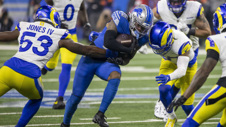 Jan 14, 2024; Detroit, Michigan, USA; Detroit Lions running back Jahmyr Gibbs (26) is tackled by Los Angeles Rams linebacker Ernest Jones (53) and linebacker Michael Hoecht (97) during the first half of a 2024 NFC wild card game at Ford Field. Mandatory Credit: David Reginek-USA TODAY Sports