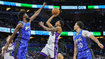Mar 23, 2024; Orlando, Florida, USA; Sacramento Kings guard Malik Monk (0) shoots the ball against Orlando Magic forward Jonathan Isaac (1) during the second quarter at KIA Center. Mandatory Credit: Mike Watters-USA TODAY Sports