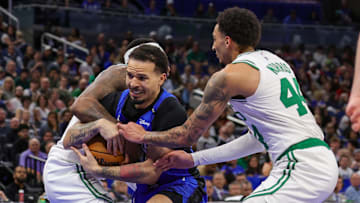 Apr 9, 2025; Orlando, Florida, USA; Orlando Magic guard Cole Anthony (50), Boston Celtics forward Miles Norris (44) and forward Torrey Craig (12) battle for the ball during the second half at Kia Center. Mandatory Credit: Mike Watters-Imagn Images