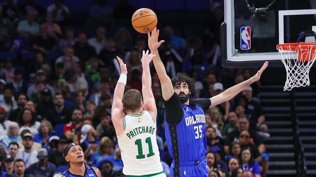 Boston Celtics guard Payton Pritchard shoots against Orlando Magic center Goga Bitadze.