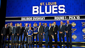 Jun 28, 2023; Nashville, Tennessee, USA; St. Louis Blues draft pick Dalibor Dvorsky stands with Blues staff after being selected with the tenth pick in round one of the 2023 NHL Draft at Bridgestone Arena. Mandatory Credit: Christopher Hanewinckel-Imagn Images