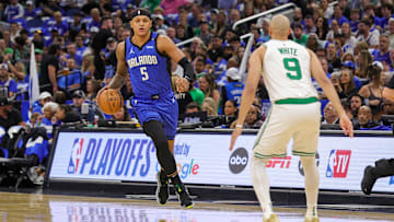 Orlando Magic forward Paolo Banchero (5) brings the ball up court against Boston Celtics guard Derrick White (9) during the first quarter of game three of first round for the 2024 NBA Playoffs at Kia Center.