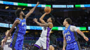 Mar 23, 2024; Orlando, Florida, USA; Sacramento Kings guard Malik Monk (0) shoots the ball against Orlando Magic forward Jonathan Isaac (1) during the second quarter at KIA Center. 