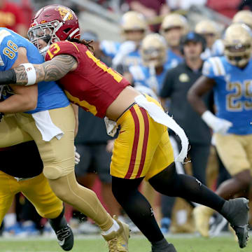 Nov 18, 2023; Los Angeles, California, USA; USC Trojans linebacker Mason Cobb (13) tackles UCLA Bruins tight end Moliki Matavao (88) during the first quarter at United Airlines Field at Los Angeles Memorial Coliseum. Mandatory Credit: Jason Parkhurst-Imagn Images