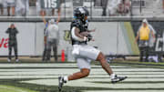 Nov 2, 2024; Orlando, Florida, USA; UCF Knights running back RJ Harvey (7) scores a touchdown against the Arizona Wildcats during the first quarter at FBC Mortgage Stadium. Mandatory Credit: Mike Watters-Imagn Images