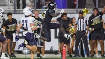 Aug 29, 2024; Orlando, Florida, USA; UCF Knights running back Myles Montgomery (22) scores a touchdown during the second half against the New Hampshire Wildcats at FBC Mortgage Stadium. Mandatory Credit: Mike Watters-Imagn Images