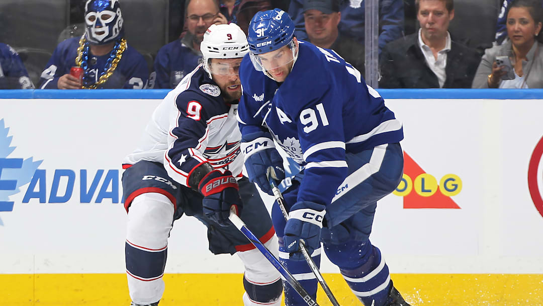 Blue Jackets defenseman Ivan Provorov battles with Maple Leafs forward John Tavares.