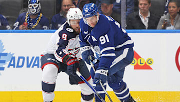 Blue Jackets defenseman Ivan Provorov battles with Maple Leafs forward John Tavares.