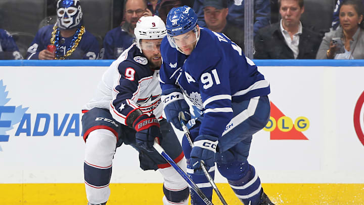 Blue Jackets defenseman Ivan Provorov battles with Maple Leafs forward John Tavares.
