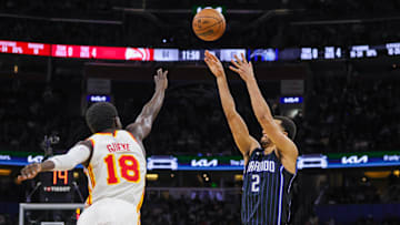 Magic guard Caleb Houstan (2) shoots a three point basket against Hawks forward Mo Gueye (18) during a game at Kia Center. 