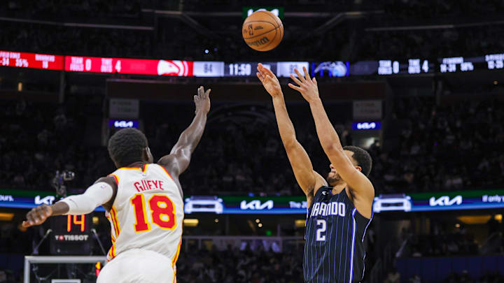 Magic guard Caleb Houstan (2) shoots a three point basket against Hawks forward Mo Gueye (18) during a game at Kia Center. 