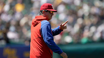 Philadelphia Phillies manager Rob Thomson pointing to the bullpen