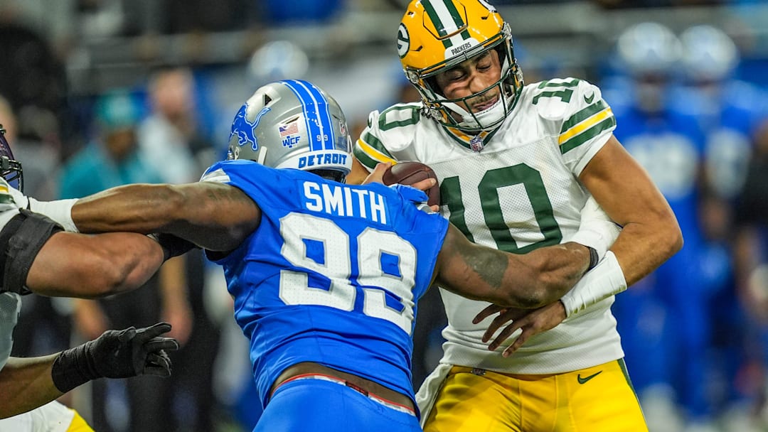 Green Bay Packers quarterback Jordan Love (10) is sacked by Detroit Lions defensive end Za'Darius Smith (99), during the Thursday Night Football at Ford Field in Detroit on Thursday, Dec. 5, 2024.
