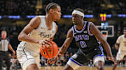 Feb 1, 2025; Orlando, Florida, USA; UCF Knights guard Keyshawn Hall (4) handles the ball in front of Brigham Young Cougars forward Mawot Mag (0) during the first half at Addition Financial Arena. Mandatory Credit: Mike Watters-Imagn Images