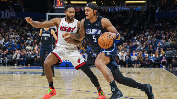 Orlando Magic forward Paolo Banchero (5) drives to the basket in front of Miami Heat forward Haywood Highsmith (24) during the second half at the Kia Center.