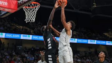 Feb 5, 2025; Orlando, Florida, USA; UCF Knights guard Keyshawn Hall (4) goes to the basket against Cincinnati Bearcats forward Aziz Bandaogo (55) during the second half at Addition Financial Arena. Mandatory Credit: Mike Watters-Imagn Images