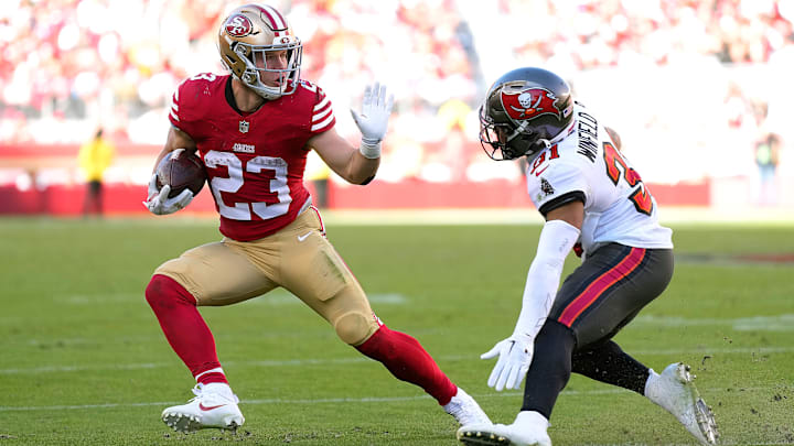 Tampa Bay Buccaneers safety Antoine Winfield (R) and San Francisco 49ers running back Christian McCaffrey (L)