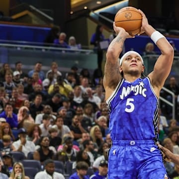 Orlando Magic forward Paolo Banchero (5) shoots the ball against LA Clippers guard James Harden (1) during the second quarter at KIA Center.