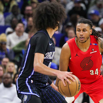 Jan 23, 2025; Orlando, Florida, USA; Portland Trail Blazers forward Jabari Walker (34) defends Orlando Magic guard Anthony Black (0) during the second half at Kia Center. Mandatory Credit: Mike Watters-Imagn Images