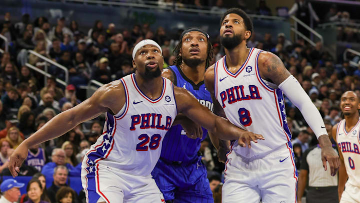 Jan 12, 2025; Orlando, Florida, USA; Philadelphia 76ers forward Guerschon Yabusele (28) and forward Paul George (8) defend Orlando Magic center Wendell Carter Jr. (34) for the rebound during the second half at Kia Center. Mandatory Credit: Mike Watters-Imagn Images