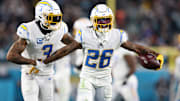 Jan 14, 2023; Jacksonville, Florida, USA; Los Angeles Chargers cornerback Asante Samuel Jr. (26) celebrates with safety Derwin James Jr. (3) after an interception during the second quarter of a wild card game against the Jacksonville Jaguars at TIAA Bank Field. Mandatory Credit: Nathan Ray Seebeck-Imagn Images
