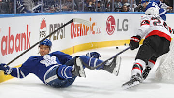 Dylan Cozens knocks over Max Domi