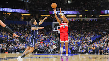 Nov 10, 2024; Orlando, Florida, USA; Washington Wizards guard Jordan Poole (13) shoots a three point basket against Orlando Magic guard Cole Anthony (50) during the second quarter at Kia Center. Mandatory Credit: Mike Watters-Imagn Images