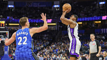 Sacramento Kings guard De'Aaron Fox (5) shoots the ball against Orlando Magic forward Franz Wagner (22) during the first quarter at KIA Center.