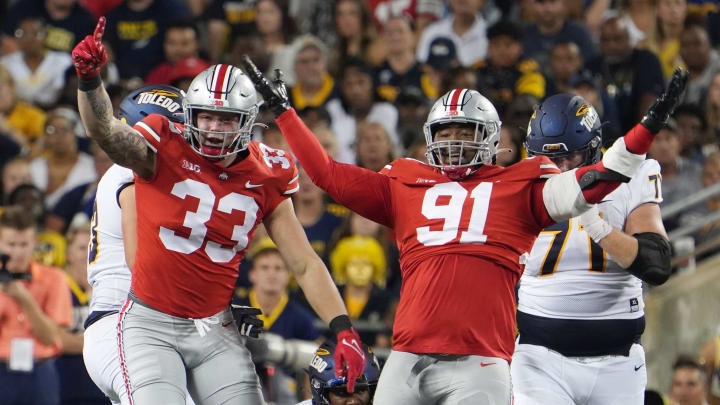 Sep 16, 2022; Columbus, Ohio, United States; Ohio State Buckeyes defensive end Jack Sawyer (33) and Ohio State Buckeyes defensive tackle Tyleik Williams (91) celebrate a sack of Toledo quarterback Dequan Finn during the Toledo game. Mandatory Credit: Doral Chenoweth/The Columbus Dispatch

Osu22tol Dc