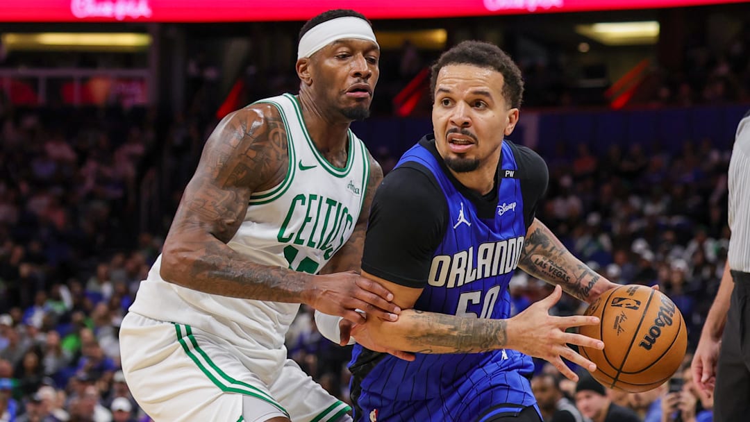 Apr 9, 2025; Orlando, Florida, USA; Orlando Magic guard Cole Anthony (50) drives past Boston Celtics forward Torrey Craig (12) during the second half at Kia Center. Mandatory Credit: Mike Watters-Imagn Images