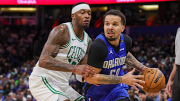 Apr 9, 2025; Orlando, Florida, USA; Orlando Magic guard Cole Anthony (50) drives past Boston Celtics forward Torrey Craig (12) during the second half at Kia Center. Mandatory Credit: Mike Watters-Imagn Images