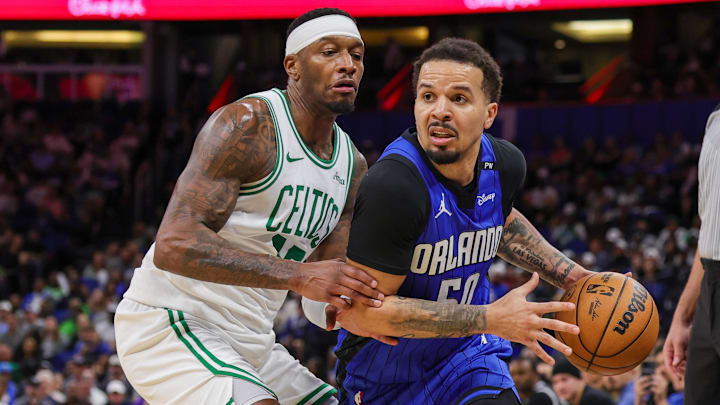Apr 9, 2025; Orlando, Florida, USA; Orlando Magic guard Cole Anthony (50) drives past Boston Celtics forward Torrey Craig (12) during the second half at Kia Center. Mandatory Credit: Mike Watters-Imagn Images