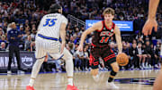 Dec 1, 2025; Orlando, Florida, USA; Chicago Bulls forward Matas Buzelis (14) drives against Orlando Magic center Goga Bitadze (35) during the second half at Kia Center. Mandatory Credit: Mike Watters-Imagn Images